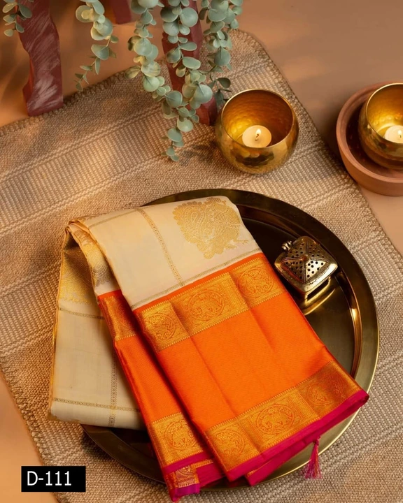 

Gleaming Like An Exquisite Pearl, This Cream Kanchipuram Silk Saree Enchants With A Striking Confl uploaded by Vishal trendz 1011 avadh textile market on 2/18/2023