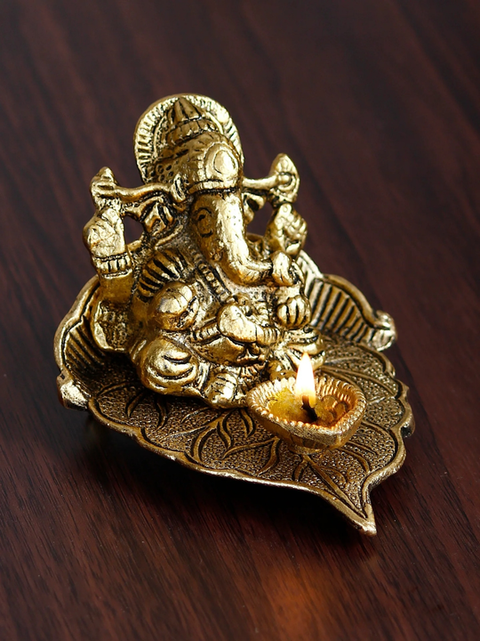 Golden Metal Handcrafted Lord Ganesha Idol with Diya on Leaf
 uploaded by Home decor on 5/12/2023
