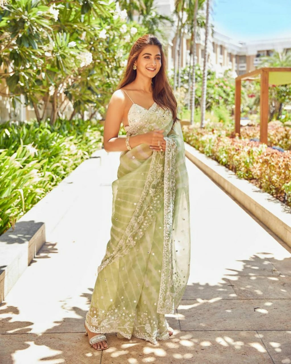 Green colored organza silk saree uploaded by Celeb Styles on 6/7/2023