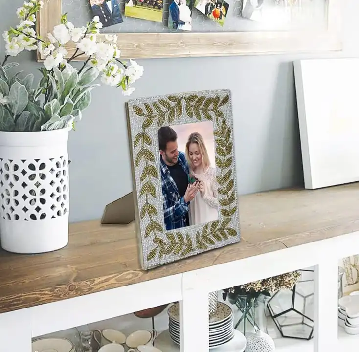 Post image *Premium Handcrafted Beautiful Beaded Photo Frame*

Cherish your sweet memories by displaying your photographs in this table top rectangular photo frame set with a classic Flower.

- Gifting
- Home Decor / Table Decor 

Material : Wooden frame decorated with beaded work .

Size   : 8*10 inches approx .