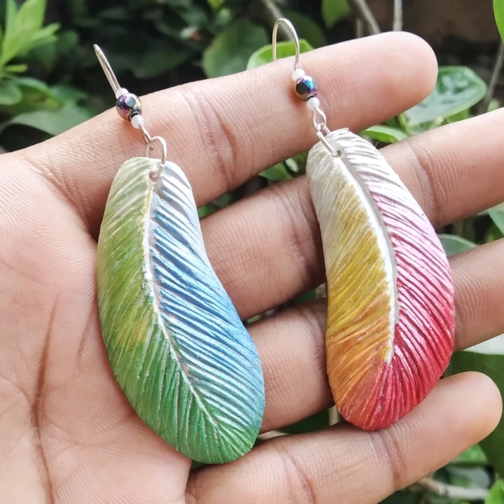 Rainbow feathers earrings pearl colour  uploaded by business on 7/2/2023