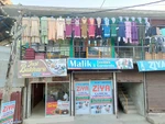 Business logo of Malik Textiles and Garments