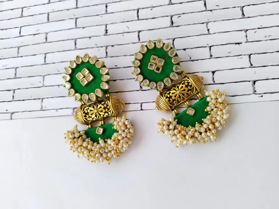 Green heavy studded earrings uploaded by business on 7/26/2023