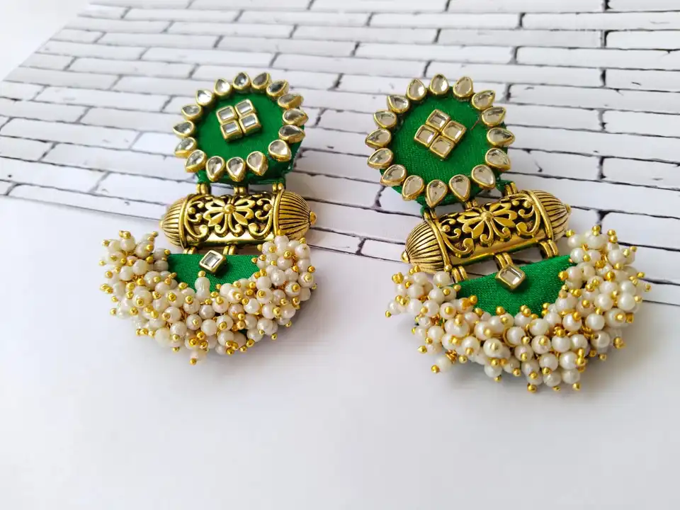 Green heavy studded earrings uploaded by The serene by Rainvas on 7/26/2023