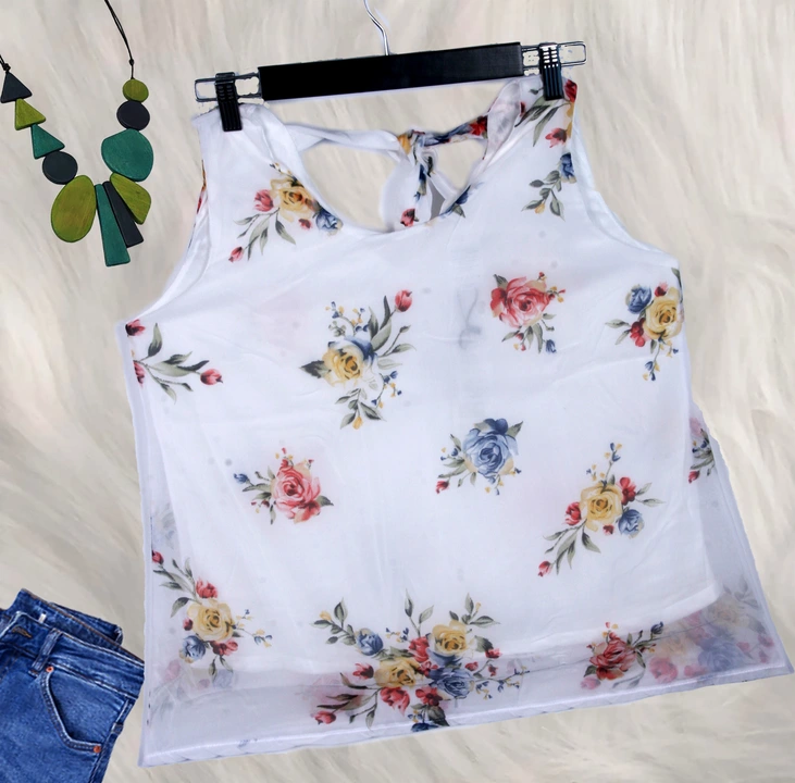 Post image Name: trendy flower print Georgette 
             Women's top
Colour: white 
    Print: bright floral
Fabric: Georgette
Style: tie ups on back 
            Round neck on front
 Light weight with inner lining
Occasion: party , festive 
Weight : 180 gm /  piece
