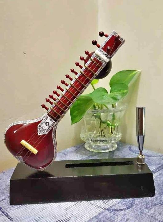 Post image A very artistic miniature of Sitar with cardholder &amp; Pen stand which will elaborate your office/ study desk. Unique &amp; precious gifting item for your loved ones. 
Material: Wood &amp; metal
