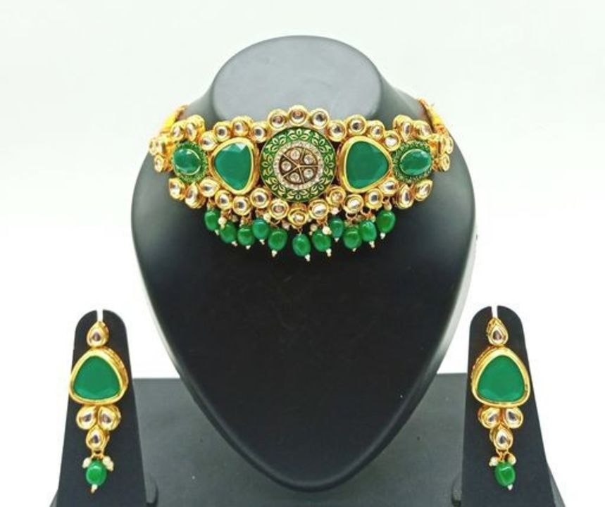 Post image Free delivery
Gold Plated Round Dabbi Kundan Triangle Green Choker Set 
Base Metal: Alloy
Plating: Gold Plated
Stone Type: Kundan
Sizing: Adjustable
Type: Necklace and Earrings