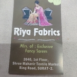Business logo of Riya fabrics (whole sale of sarees)