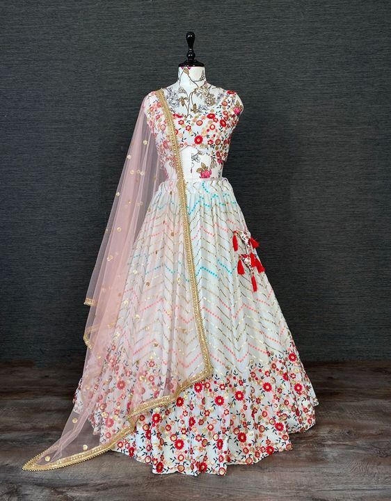Post image *🌷Lehenga Choli🌷*
Feel like the best version of yourself in this beautiful lehenga in white hues embellished in sequins and thread floral work. This Lehenga is ideal for a wedding function.
*LNB1401WHT*
*Lehenga(Stitched)*Lehenga Fabric : GeorgetteLehenga Work : Sequins and Thread Embroidery Work Waist : Support Up To 42Stitching : Stitched With CanvasLehenga Closer : Drawstring with *Heavy Hand Made Tassels*Length : 41Flair : 3.5 Mtr Inner : Micro Cotton           
*Dupatta*Dupatta Fabric : Soft Net Dupatta Work : Sequins Butties all over with pearl lace borderDupatta Length : 2.5 Mtr 
*Blouse(Unstitched)*Blouse Fabric : Georgette Blouse Work : Sequins and Thread Embroidery WorkBlouse Length : *1 Meter*
*Package Contain :* Lehenga, Dupatta, Blouse, Drawstring, Tassels
Weight : 1.060 kg 
*Price : 2350*
#georgettelehenga #weddingdress #style #indianoutfit #whitelehenga #embroiderywork #fashion #lehengacholi