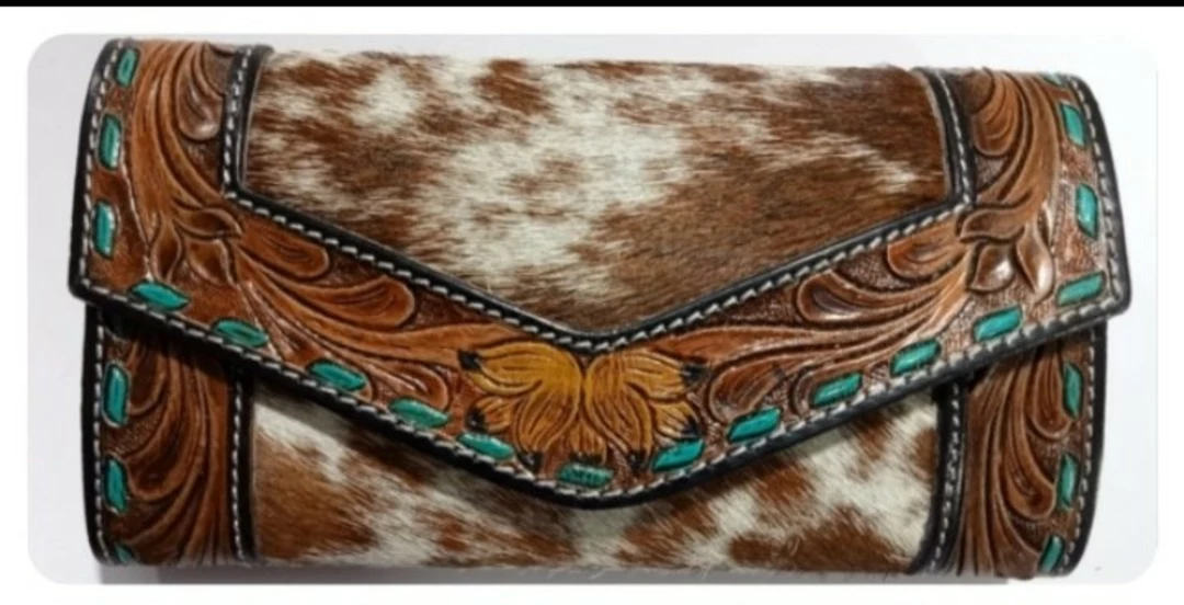 Wallet / cluthes hand work of tooling with hairon cow hide.  uploaded by R&G world on 5/28/2022