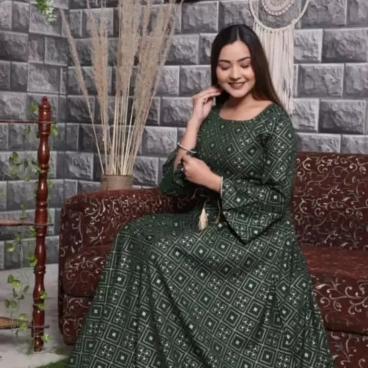 Post image *Premium rayon *anarkali gown with foil work..**Having gold print work and with beautiful Dori belt with resham Tussels &amp; designer frill sleeves**Bottle green colour*
*Colour as in live pic*
  *Lenth--. 52*. 
   *Size s to xxxl*  *36,38,40,42,44,46*

**